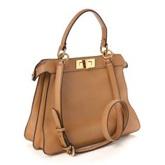 This is an authentic FENDI Vitello Seta Shiny Nappa Medium Peekaboo I SEE U Satchel in Miele Scuro and Light Rose. This chic tote is finely crafted of light brown calfskin leather. This medium-sized bag features gold squared turn locks on either side that when released, relax the outer layer to reveal a chenille inner panel, a matching top handle, an optional shoulder strap, and gold hardware. This opens to a partitioned pink leather interior with a removable pouch. Pokemon Fabric, Fendi Peekaboo Bag, Fendi Shoulder Bag, Fendi Peekaboo, Medium Sized Bags, Python Print, Rose Lights, Blue Velvet, Pink Leather