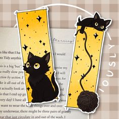 two black cats sitting next to each other in front of an open book with text