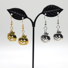 Handmade earrings featuring either a gold or silver pumpkin charm! Celebrate Halloween the spooky way with these cute dangle earrings.  Featuring either a silver-color or gold-color charm, these earrings will go with most costumes. Adjustable Gold Jewelry For Halloween, Halloween Hypoallergenic Metal Jewelry, Hypoallergenic Jewelry For Halloween Party, Spooky Silver Dangle Earrings, Nickel-free Silver Earrings For Halloween, Silver Metal Earrings For Halloween, Fall Season Gift Dangle Earrings, Hypoallergenic Jewelry For Halloween Gift, Hypoallergenic Jewelry Gift For Halloween