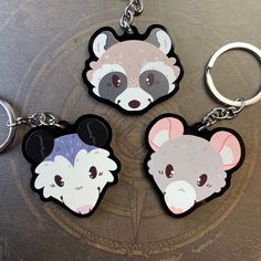 three key chains with cartoon animals on them