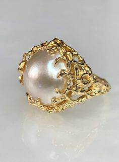 "Mabe Pearl Ring, Pearl Gold Ring, Vintage Mobe Pearl Ring, Pearl Cocktail Ring, Pearl Statement Ring, Large Pearl Ring, 14k Solid Gold Ring A romantic and feminine one of a kind genuine \"Mabe\" pearl ring with unique golden \"branches\" as prongs set in 14k yellow gold. * Ring size: US 6" Exquisite High Luster Rings For Gifts, 14k Gold High Luster Rings As A Gift, High Luster 14k Gold Rings For Gift, 14k Gold Rings With High Luster For Gift, Heirloom High Luster Ring Jewelry, Heirloom High Luster Ring, High Luster 14k Gold Pearl Ring As Gift, Handmade Elegant Yellow Gold Dome Ring, 14k Gold Pearl Ring With High Luster