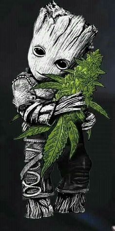 the baby grooter is holding a plant in his hands