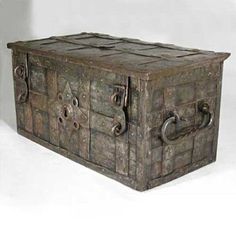 an old wooden box with metal handles and latches on the front, sitting on a white surface