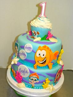 a birthday cake decorated with an image of the number one fish and sea life on it