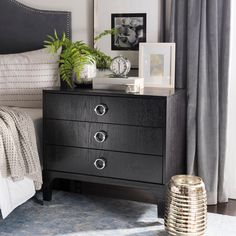 a bedroom scene with focus on the nightstand and bed side table in the foreground