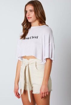 STYLE INFORMATION: Vacay in cosmopolitan style in the Mon Chéri White Cropped Graphic Tee! Lightweight woven white fabric with a black print graphic that reads "mon chéri" in a bold font. Oversize silhouette, short sleeves, a crew neckline, and a crop top hem finishes this cute graphic tee. DETAILS & CARE: Rayon/Polyester. Machine Wash. Imported. SHIPPING: Orders are processed within 1-2 business days. Packages are shipped out Monday-Friday, holidays are excluded. Chic Crew Neck Cropped T-shirt For Summer, Chic Summer Streetwear T-shirt, Trendy Oversized Cropped T-shirt For Summer, White Cropped T-shirt With Text Print For Spring, White Relaxed Fit Cropped T-shirt With Text Print, White Cropped T-shirt With Text Print, Relaxed Fit, White Cotton Cropped T-shirt For Spring, White Cropped T-shirt With Text Print, White Short Sleeve Cropped T-shirt With Text Print