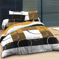 a bed in a room with black and yellow comforter sets on it's side