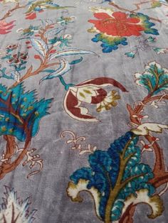 the bed is covered with an intricately designed comforter