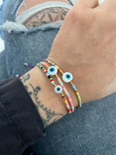 Unique simple yet powerful colorful beaded bracelets with a flat evil eye bead in the middle. Fun and colorful bracelets that will keep you safe and stylish at the same time. Perfect for layering if you like to wear many accessories. They are size adjustable, so this are the perfect gift for your love ones. They are available in 3 different colors for you to choose from. Red, Pastel and Purpel. (you can define them by the string color) A most have addition to your everyday bracelets. ⚡️GET 20% O Festival Evil Eye Bracelet With Colorful Round Beads, Bohemian Evil Eye Bracelet With Round Letter Beads, Bohemian Evil Eye Bracelet With Letter Beads, Multicolor Evil Eye Beaded Bracelets For Friendship, Adjustable Multicolor Evil Eye Beads, Multicolor Evil Eye Bracelet With Colorful Round Beads, Evil Eye Round Beads Friendship Bracelets For Festival, Adjustable Multicolor Evil Eye Bracelet With Tiny Beads, Evil Eye Friendship Bracelets With Round Beads For Festivals