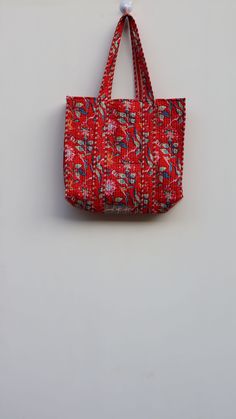 One~of~A~Kind Vintage Kantha Jhola Bag made by Indian Artisans, this kantha hopping bag is totally unique and multi purpose. Use this for your grocery or as a travel bag. Perfect to suit all. Size in Inch:- Height-19" inch Width- 25" inch Handle-11" inch Size In CM:- 40x40x13 cm Handle height- 35 cm Material: 100% Cotton Pattern: Quilted Style: Ethnic Product Work: Printed & quilted Stitched Usage : Cosmetic, Make-up, Travel, Toiletries, Medicine, Accessories, Shopping and much more. Perfect for Small Handmade Bags For Daily Use, Small Handmade Bag For Daily Use, Red Shoulder Bag As Festival Gift, Red Shoulder Bag For Festivals As Gift, Red Shoulder Bag For Festivals, Red Shoulder Bag For Festivals And Gifts, Eco-friendly Red Gift Bag, Traditional Tote Bag For Shopping, Traditional Rectangular Bag With Handles