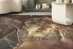 a bathroom with marble flooring and walls in grey, gold and white colors is pictured