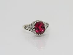 Vintage Sterling Silver Oval cut Ruby Filigree Ring...Marked 925...Total of weights 2.8grams.. Size 9...Measure of Face 10.9mm...It's in very good condition Formal Oval Engraved Filigree Ring, Classic Oval Engraved Ring With Filigree, Antique Oval Ruby Ring With Filigree Details, Antique Oval Ruby Ring With Filigree, Classic Oval Ruby Ring With Filigree, Ornate Hallmarked Oval Engraved Ring, Ornate Oval Engraved Hallmarked Ring, Heirloom Oval Ruby Ring With Filigree, Ornate Oval Ruby Ring With Filigree