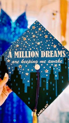 a person holding up a graduation cap that says, a million dreams are being awarded