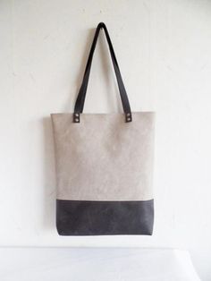 Large vegan leather tote - color block vegan leather tote bag in grafitti grey and dove grey. * Exterior: - Bottom - high quality vegan leather in gorgeous grafitti grey color -Top - high quality very durable vegan leather in beautiful dove grey color. * Interior: - Natural cotton polka dot lining in dove grey and white. * Two inside slip pockets * Real leather handles in black attached with silver toned rivets * Closes with magnetic snap closure reinforced with natural leather Measurements: Hei Gray Bags With Leather Handles For Shopping, Gray Tote Bag For Errands, Gray Double Handle Shoulder Bag With Leather Handles, Gray Canvas Tote Bag, Gray Bags With Leather Handles For Everyday Use, Gray Satchel Canvas Bag For Everyday, Everyday Large Capacity Gray Canvas Bag, Gray Canvas Shoulder Bag With Leather Handles, Gray Bags With Leather Handles