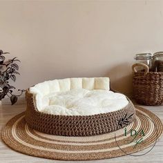 a dog bed is shown on the floor next to some baskets and other things in front of it