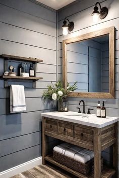 a bathroom with gray walls and wood floors, white towels on the shelf above the sink