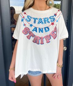 Embrace the patriotic spirit with our Stars and Stripes Top! Featuring sequined stars and stripes garland embroidery, this short sleeve top will add a touch of glamour to any outfit. The asymmetric high-low cut and round neck provide a comfortable and stylish fit. Perfect for showing off your American pride! Maddy is wearing a size Small. Height is 5’7, Bust is 34”, Waist 27”, and Hips 33”. Stripes Top, Vintage Havana, Top Graphic Tees, American Pride, Stars And Stripes, Sweater Set, Mens Outerwear, New Arrival Dress, Mens Graphic Tee