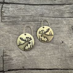 Experience the beauty of the wilderness with our Creek Moose Earrings. Adorned with the majestic moose, these earrings capture the essence of spotting a moose in tall grass by a river. Let the large antlers of the moose inspire you to embrace your strength and grace. The two earrings are reflective as they face each other. For the silver finish, the ear wires are sterling silver, and for the antique brass finish, we use 14k gold filled. This style is offered in two finishes: Matte Silver and Ant Moose Jewelry, Two Earrings, Cuff Rings, The Wilderness, Antique Earrings, Leather Cuffs, Antlers, Brass Finish, Adjustable Rings