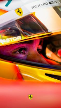 a close up of a person in a race car with the driver's helmet on