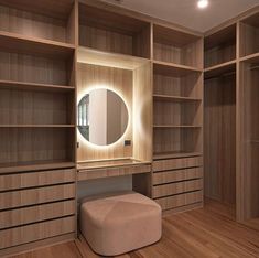 an empty dressing room with wooden shelves and mirrors on the wall, along with a stool