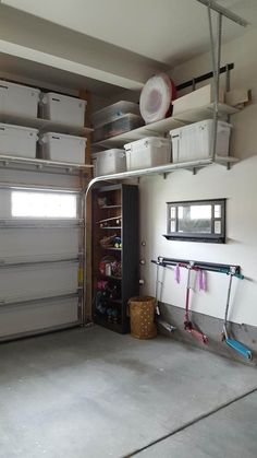 a garage with several storage bins on the wall