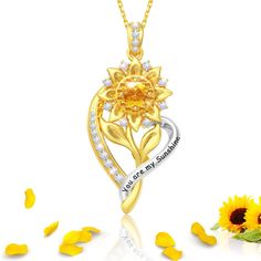 PRICES MAY VARY. 🌻【 Sunflower Gifts for Women 】：You Are My Sunshine Necklace for women combines sunflower and heart shapes, Be like a sunflower facing the sun and never forget that you are loved. Gold sunflower necklace is a special gift for sunflower lovers, also as a gift for your best friend,sister,daughter,granddaughter or yourself 🌻【 S925 Sterling Silver Necklace 】：Gold sunflower necklace with 5A cubic zirconia, made of S925 sterling silver and 18K gold plated filled, non-tarnish, hypoall Gold Sunflower Design Necklace, Gold Sunflower Necklace For Gift, Elegant Necklace With Sunflower Pendant, Silver Sunflower Pendant Jewelry, Elegant Sunflower Pendant Necklace, Sunshine Necklace, Sunflower Jewelry, Sunflower Gifts, 18k Gold Necklace