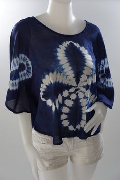 a mannequin wearing a blue and white tie - dyed top with short sleeves