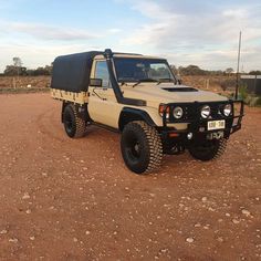 an off - road vehicle is parked in the dirt