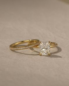 a close up of a ring with a diamond in it on a white tablecloth