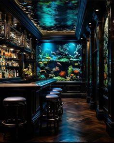 an aquarium is shown in the middle of a bar with stools and shelves full of bottles