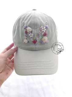 Hand Embroidered Letter Hat Baseball Cap Material: This khaki fabric cap is embroidered with cotton thread. You can adjust circumference of the hat. - Cap circumference : 54-58 cm - Cap depth: 12 cm - Cap brim length: 7 cm -Color: Green grey I love embroidery and I think this is a gift of thought for this life. If you like, own it or give this meaningful gift to relatives and friends. NOTE: The color can slightly be different due to monitor setting. Please make sure you do not mind this when pur Custom Baseball Cap, Love Embroidery, Airbnb Promotion, Pretty Hats, Embroidery Caps, Denim Cap, Flower Hat, Floral Hat, Hat Baseball