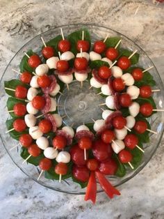 a wreath made out of tomatoes and meat on skewers