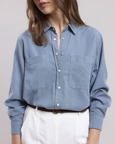 Women's cotton gabardine shirt with long sleeves and simple cuffs. Visible snap button placket. Two patch pockets. Blue Long Sleeve Shirt With Patch Pockets, Blue Button-up Shirt With Patch Pockets, Oversized Cotton Shirt With Snap Buttons, Blue Classic Shirt With Patch Pockets, Classic Blue Shirt With Patch Pockets, Washed Blue Button-up Shirt With Patch Pockets, Long Sleeve Washed Blue Shirt With Button Cuffs, Washed Blue Long Sleeve Shirt With Button Cuffs, Blue Work Shirt With Patch Pockets