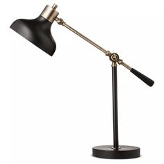 a black and gold desk lamp on a metal base with an arm that is bent to the side