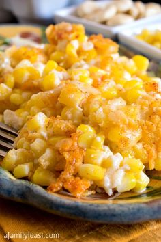 a close up of a plate of food with broccoli and corn on it