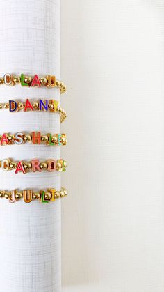 It's ready to be personalized, and you get a stack of 3! Select the colorful cutout letters (up to 8) to make your own custom bracelet, stacked with a matching 4mm round bead bracelets as well as a 6mm round bead bracelet. The custom bracelet features 5mm round beads to make the perfect stack for a personalized gift or for your collection. Dimensions: 5.5", 6.25", 7", 7.5", 8" Personalized Letter Beads Bracelets, Personalized Fun Gold Bracelets, Fun Gold Bracelets With Letter Beads, Fun Gold Beaded Bracelets With Letter Beads, Multicolor Letter Beads Name Bracelet For Personalized Gift, Multicolor Letter Beads Name Bracelet As Personalized Gift, Personalized Multicolor Name Bracelet With Letter Beads, Personalized Multicolor Letter Beads Name Bracelet, Fun Custom Name Jewelry With Round Beads