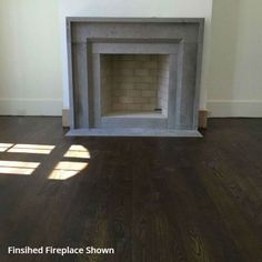 an empty fireplace in the corner of a room