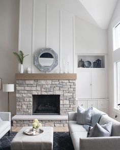 a living room filled with furniture and a fire place