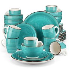 a set of blue dishes and cups with white rims