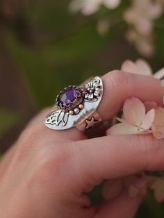 This magical shield ring was designed to protect you from evil and make you feel confident and happy in your skin. Entirely handcrafted in sterling silver, this ring features a lovely faceted amethyst gemstone and handmade embellishments. Size 6.5, but due to its wide band, the ring will comfortably fit size 6. You can see how this ring was made in this video: ➥ All Stardust Mine products are made by hand of a real person and not machine, using precious and semi-precious metals and natural stone Spiritual Amethyst Ring With Accent Stones, Spiritual Silver Amethyst Ring In Sterling Silver, Unique Amethyst Rings With Gemstone Accents, Bohemian Sterling Silver Jewelry With Accent Stones, Bohemian Sterling Silver Crystal Birthstone Ring, Mystical Sterling Silver Open Crystal Ring, Handmade Oval Amethyst Spiritual Ring, Handmade Spiritual Sterling Silver Crystal Ring, Handmade Spiritual Amethyst Oval Ring