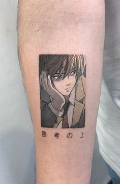 a man with a tattoo on his arm that has an anime character drawn on it