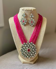 A gorgeous jewelry set consisting of one kundan and pink stone necklace with matching earrings. Pink Stone Necklace, Peach Necklace, Ruby Bangles, Red Beaded Necklaces, Agate Pendant Necklace, South Indian Jewelry, Golden Jewelry, Purple Agate, Indian Wedding Jewelry