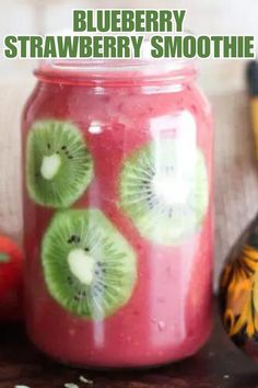 a jar filled with kiwi slices on top of a table next to bananas and apples