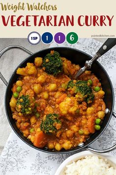 a pan filled with vegetables and rice on top of a table