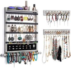 a wall mounted jewelry rack with multiple pairs of earrings hanging from it's sides