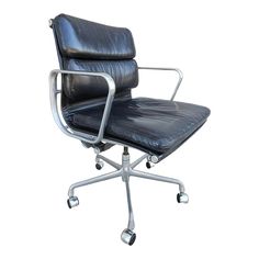 an office chair with black leather upholstered on the back and chrome frame base