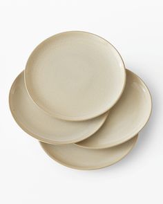 three white plates stacked on top of each other