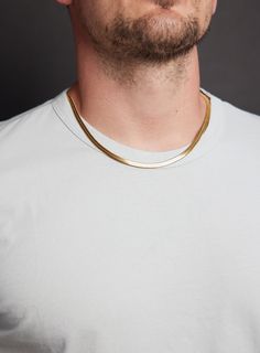 Men's Gold Chain Necklace - 5mm 14k Gold Plated 316L Stainless Steel Snake / Herringbone style link chain, minimalist sleek jewelry for guys Chain Width: 5mm Clasp: Lobster Claw Chain: 14k Gold Plated 316L Stainless Steel Length: Available in 16, 18. 20, 22, and 24. Model is wearing 20 inch chain. Note that depending on your height, build, shoulders and neck chain will fit you different. Please measure your ideal length before ordering. Jewelry For Guys, Build Shoulders, Mens Gold Chain Necklace, Sleek Jewelry, Golden Snake, White Shirt Men, Herringbone Chain, Gold Chains For Men, Summer Mood