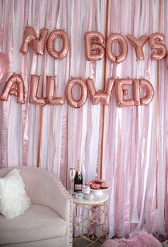 a room with pink and gold balloons that say no boys allowed