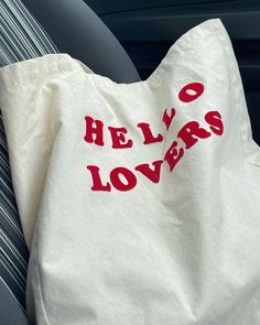 a white bag with red letters on it sitting in the back seat of a car